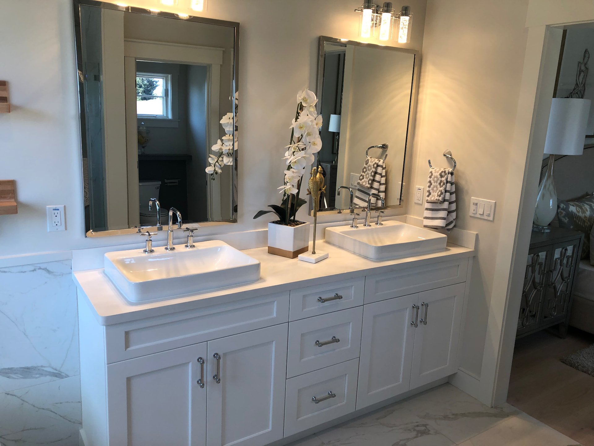 White shaker double vanity with vessel sinks and framed mirrors