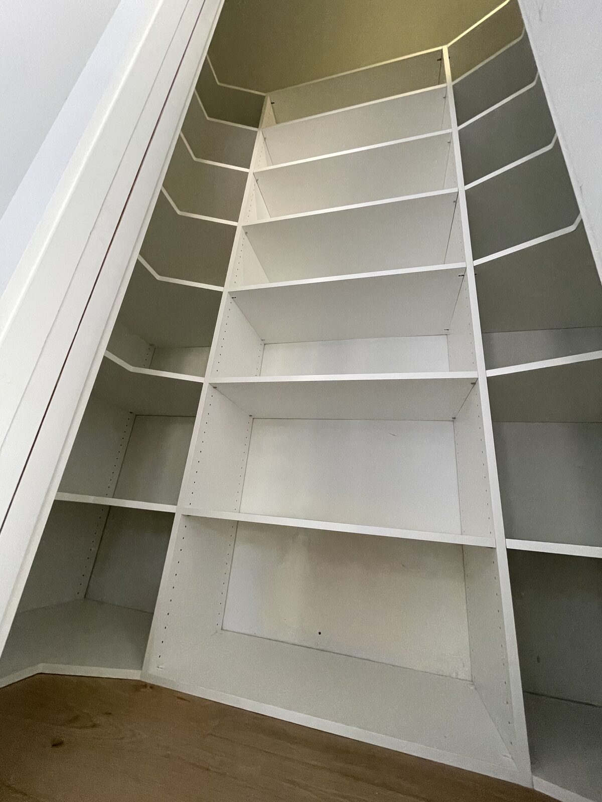 Custom closet system with hanging sections and built-in shelves