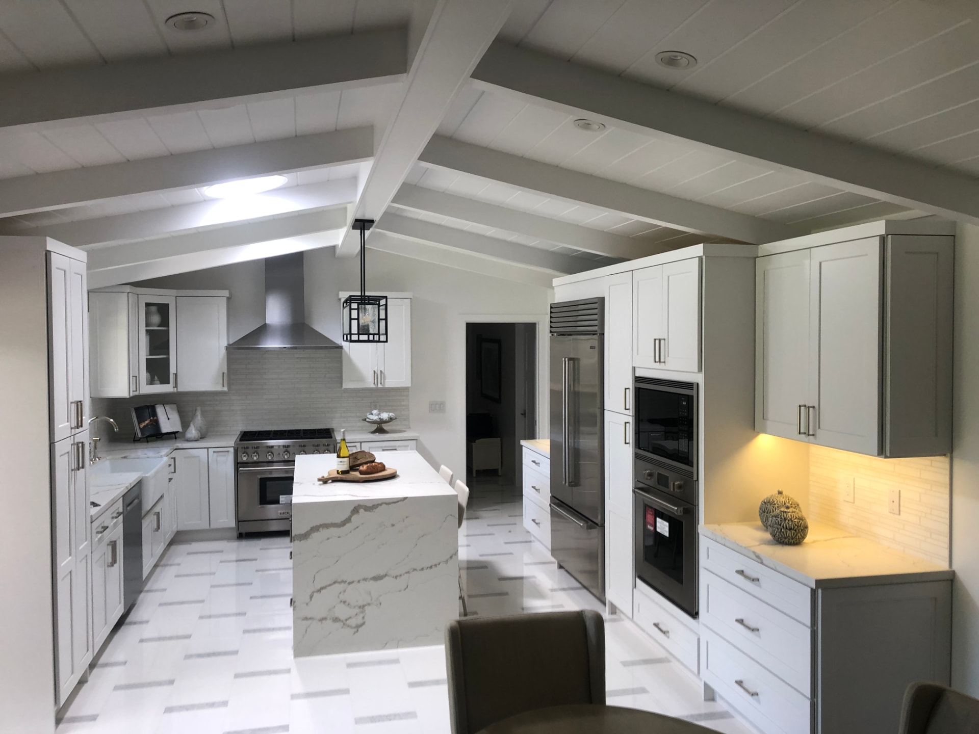 Bright white kitchen remodel with vaulted beam ceiling